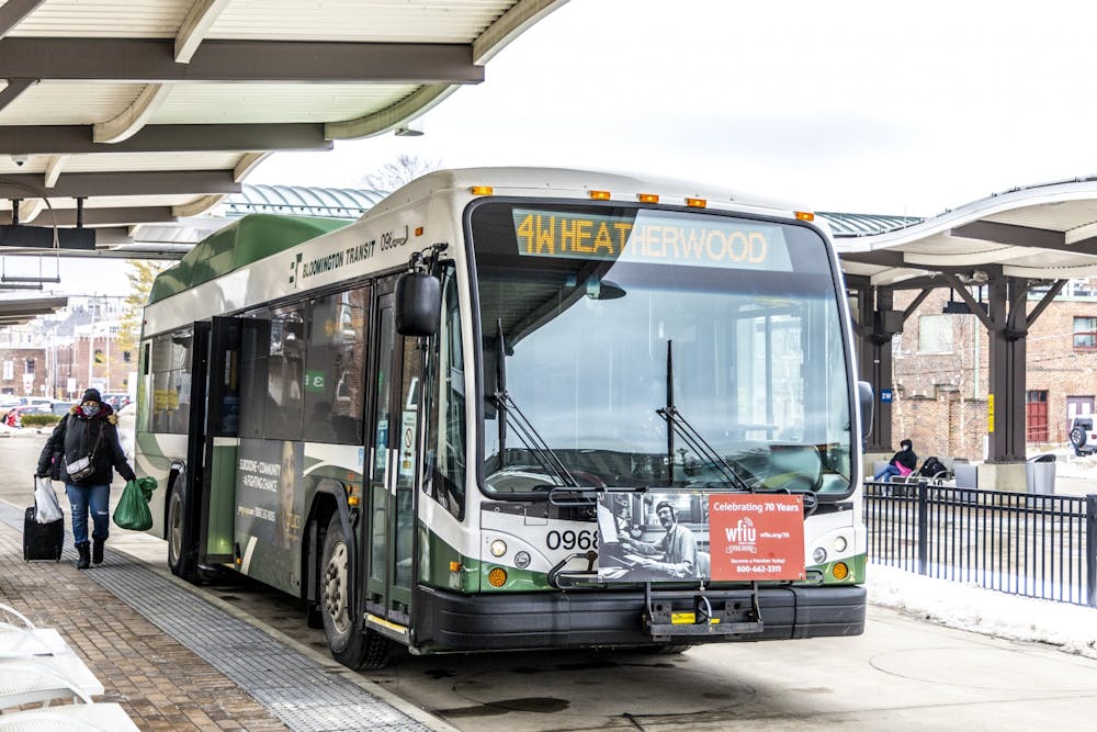<p>A woman boards a Bloomington bus Feb. 22, 2022, at the transit center. The Bloomington City Council approved a 0.69% increase in the local income tax rate Wednesday, with the largest chunk of the new revenue going towards climate change preparedness and mitigation efforts such as improving public transportation.</p>