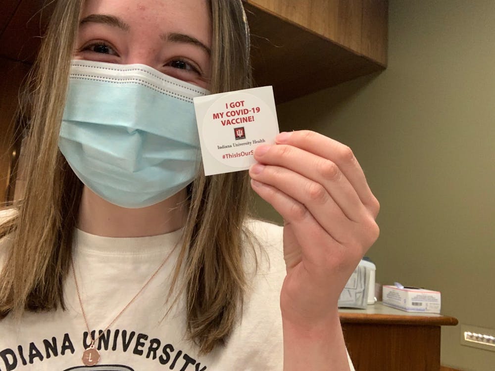 Lauren Fischer poses with her &quot;I got my COVID-19 Vaccine&quot; sticker April 4 at the IU Health Neuroscience Center in Indianapolis. Fischer got her first dose of the Pfizer vaccine.