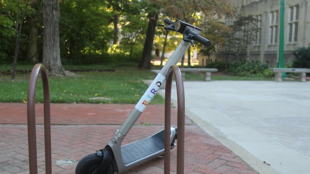 A Bird e-scooter rests on a bike stand near Dunn Woods Oct. 2, 2022. The City of Bloomington enacted a curfew for e-scooter usage beginning Oct. 13.   