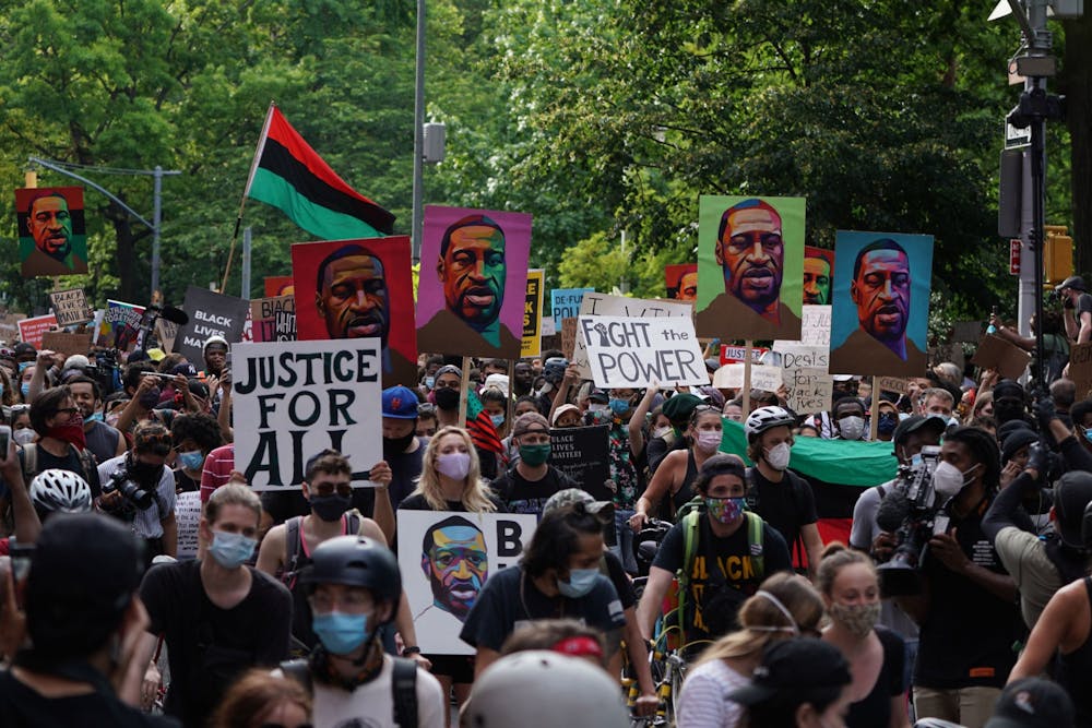 <p>Protestors march through the streets of Greenwich Village holding signs on June 19, 2020, in New York City. The protests came after George Floyd was killed by a Minneapolis Police Department officer in May.</p><p><br/></p>
