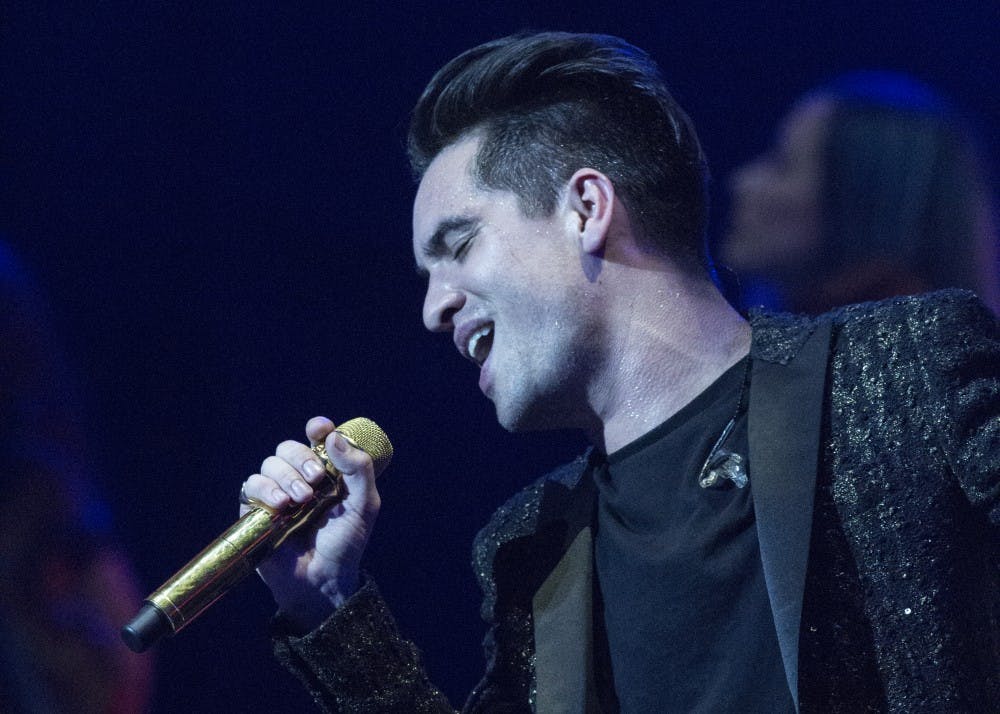 <p>Lead singer Brendon Urie performs the song “Don’t Threaten Me with a Good Time” on Friday night in Bankers Life Fieldhouse in Indianapolis.&nbsp;</p>