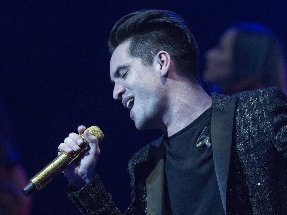 Lead singer Brendon Urie performs the song “Don’t Threaten Me with a Good Time” on Friday night in Bankers Life Fieldhouse in Indianapolis.&nbsp;