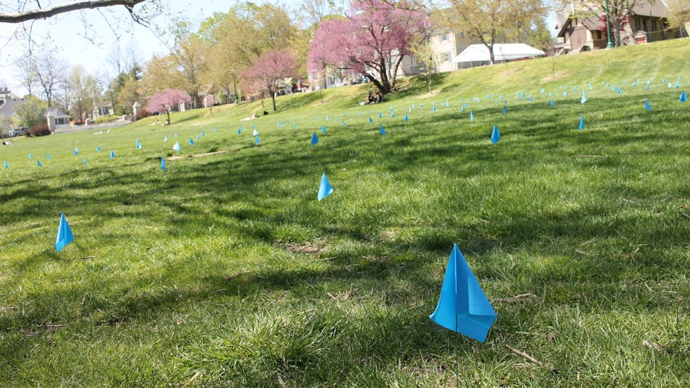 Blue flags line Dunn Meadow on Monday afternoon. The flags have been placed by Safe Sisters at IU, an organization under the Panhellenic Association, to represent the thousands of undergraduate and graduate students who have experienced nonconsensual touching or complete sexual penetration.
