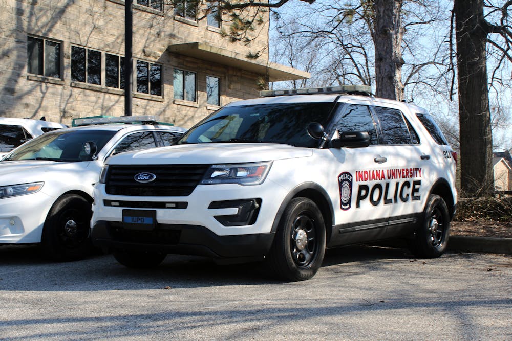 <p>IUPD police cars sit at the IUPD station on March 5, 2023, on East 17th Street. IU settled a lawsuit in September involving the arrest of an IU graduate student after he did not pay a $3 parking fee.</p>