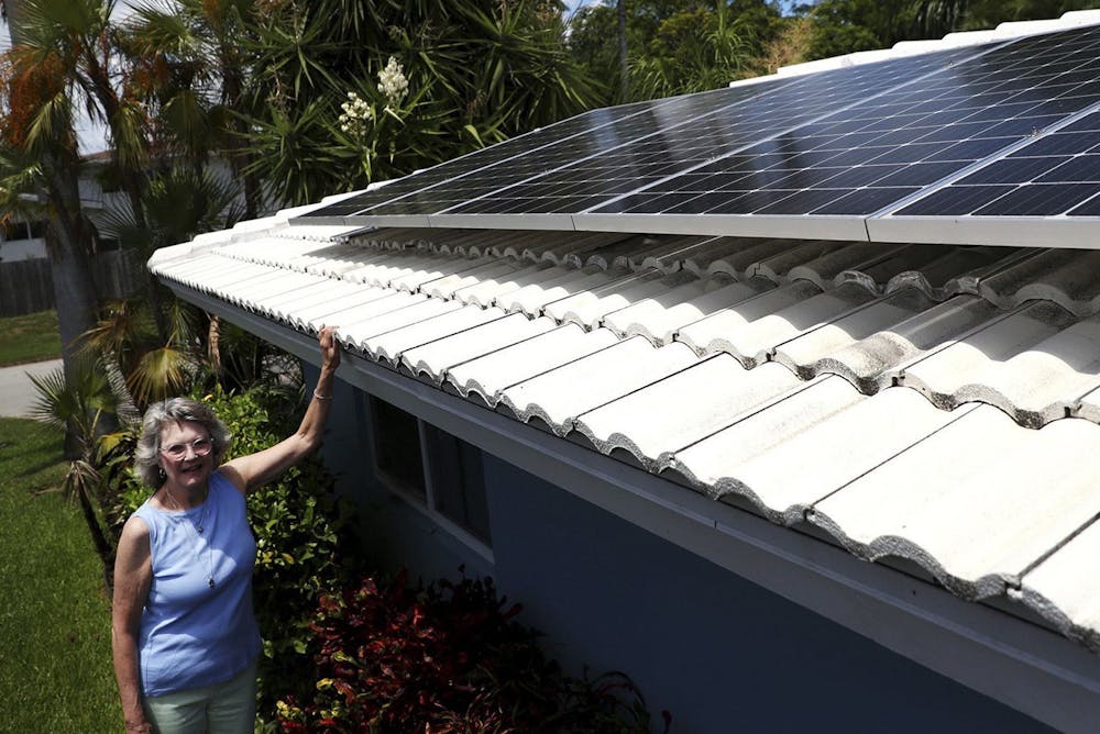 <p>Holly Strawbridge of Oakland Park, Florida shows her rooftop solar panels. The Inflantion Reduction Act, an $891 billion <a target=""></a>bill passed by the Biden administration on Aug. 16, 2022, has invested $369 billion <a target=""></a>into energy security and fighting climate change, along with tax reforms and incentives.</p>