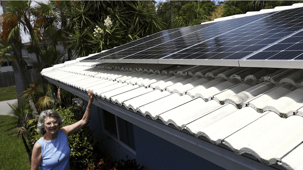 Holly Strawbridge of Oakland Park, Florida shows her rooftop solar panels. The Inflantion Reduction Act, an $891 billion bill passed by the Biden administration on Aug. 16, 2022, has invested $369 billion into energy security and fighting climate change, along with tax reforms and incentives.