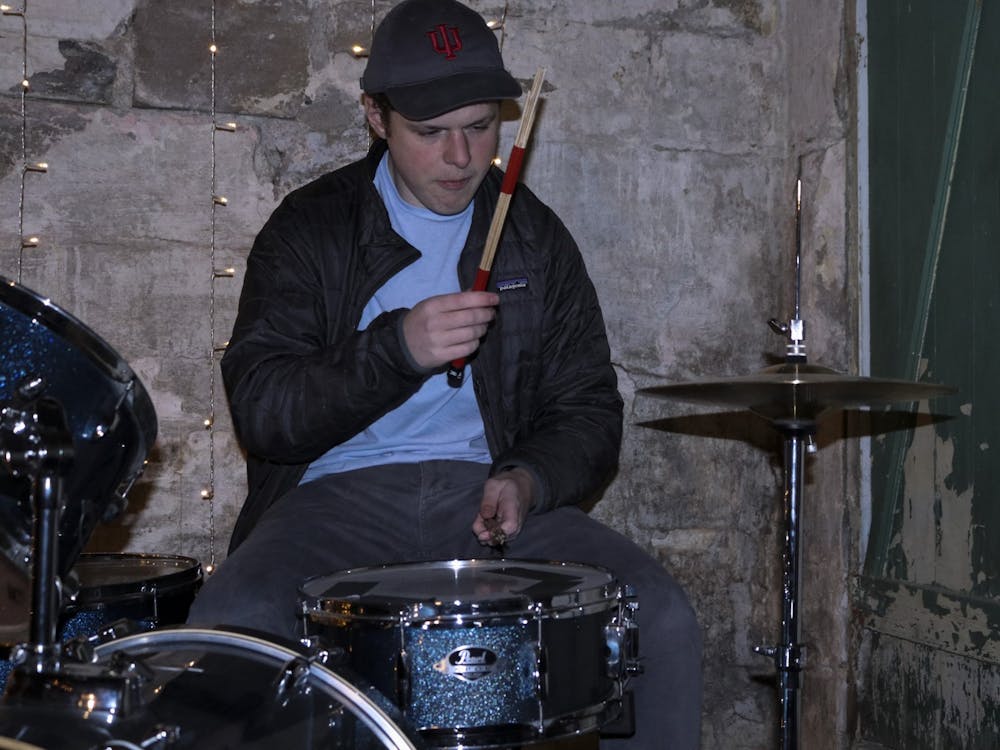 Senior Zack Berger plays on Bloomington Delta Music Club&#x27;s drum set during its jam session on Nov. 13, 2021, in Grcich&#x27;s garage.Due to its size, the drums were assembled in the garage prior to the jam session.