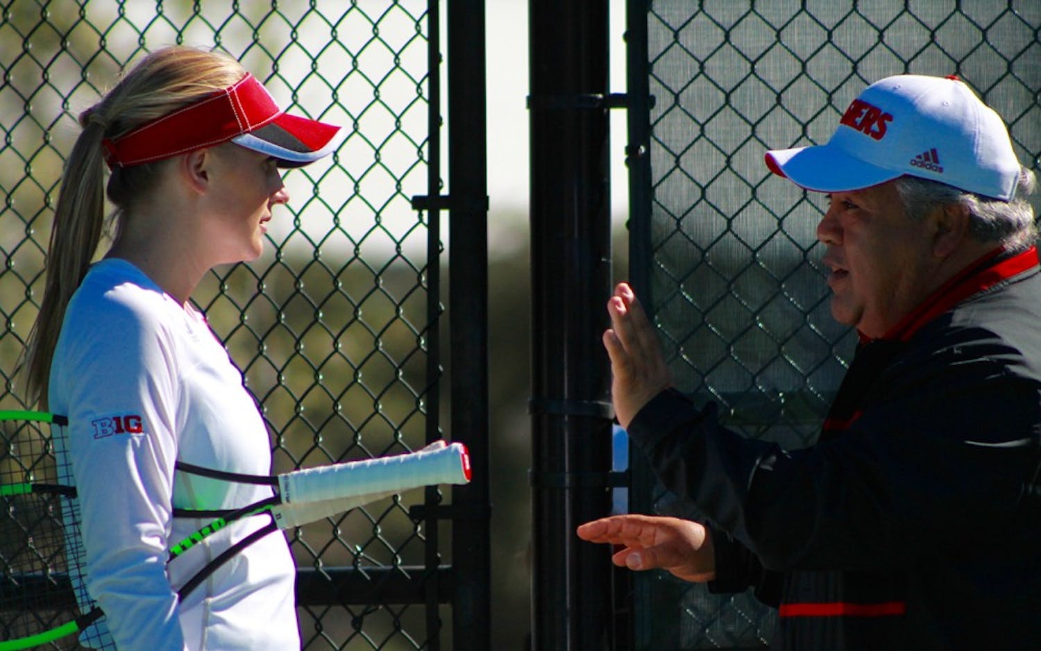 Freshman Pauline Jahren speaks with IU Coach Ramiro Azcui during a match in April. IU women's tennis took on Illinois and lost, 6-1.&nbsp;