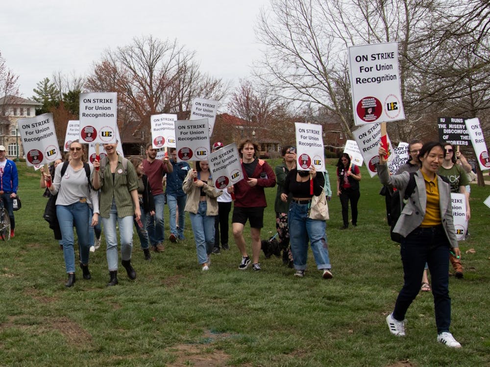 Supporters of the graduate worker strike march April 15, 2022, into Dunn Meadow. The protesters marched from the Sample Gates down Indiana Avenue. 