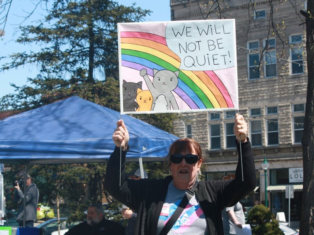 Marcie Jo Moser, a 65-year-old transgender woman, holds a sign saying &quot;We will not be quiet&quot; at a rally at the Monroe County Courthouse on April 2, 2023. Bloomington residents rallied outside the courthouse to protest the advancement of Indiana House Bill 1608 and Senate Bill 480.