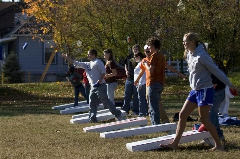 Players compete late Wednesday afternoon in a cornhole tournament at Dunn Meadow.  The event, hosted by the Student Alumni Association, will donate all proceeds to the United Way.