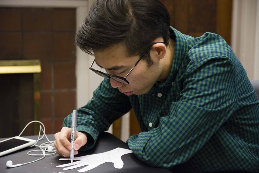 Zhengfei Sun, from China, participates in the Henna 101 event Wednesday evening at Asian Culture Center. The Henna is part of the Asian Culture. 