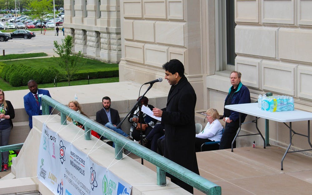 Jesse Kharbanda of the Hoosier Environmental Council rallies the crowd on Saturday. Kharbanda encouraged attendees at the March for Science to start science-related discourse with their political representatives. 