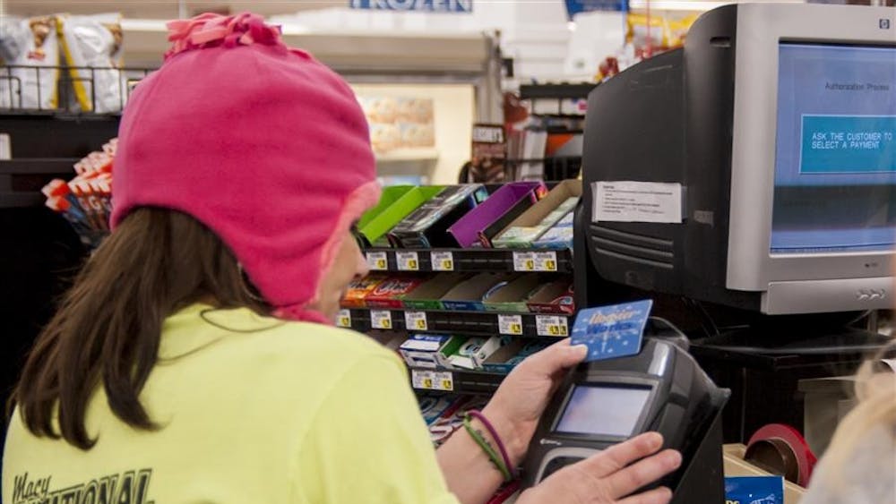 Cassie Winders, 33-year-old single mother of four, uses her EBT card to purchase food for dinner Nov. 18, 2013, at Kroger. Indiana is adding two new benefits to the Supplemental Nutrition Assistance Program, commonly known as food stamps.