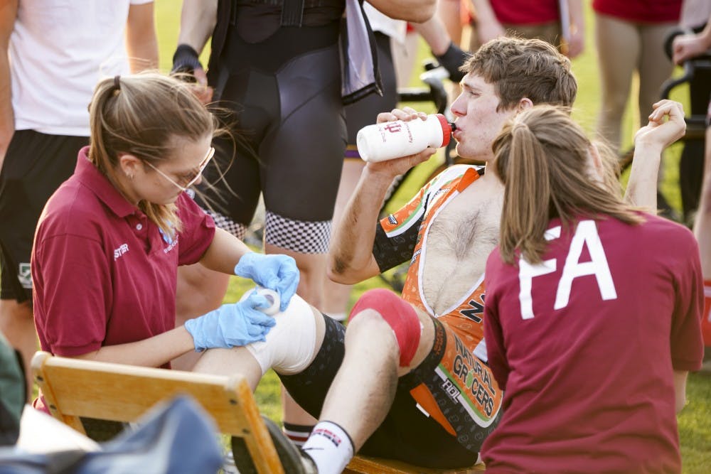 <p>Junior first aiders Olivia Houchin, left, and Olivia Elston, right, assist the wounded after a pile-up crash occurred during a practice session for Little 500 on April 12 at Bill Armstrong Stadium.</p>