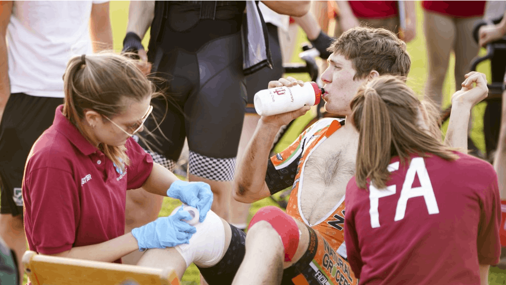 Junior first aiders Olivia Houchin, left, and Olivia Elston, right, assist the wounded after a pile-up crash occurred during a practice session for Little 500 on April 12 at Bill Armstrong Stadium.