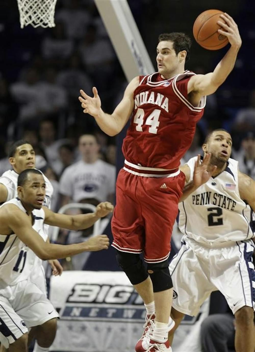 IU senior forward Kyle Taber grabs a rebound away from Penn State's Stanley Pringle, foreground left, and Jamelle Cornley, right, during the second half Saturday in State College, Pa.. Penn State won 61-58.
