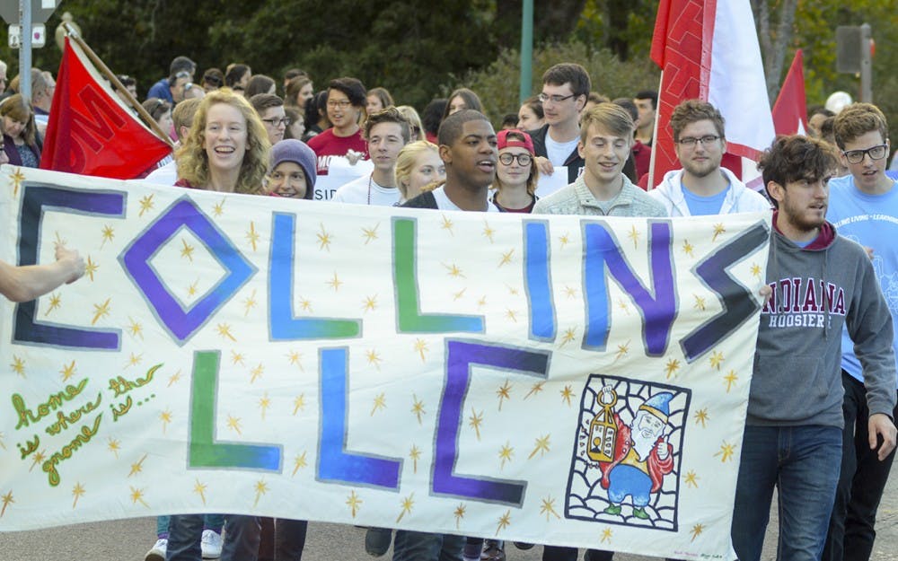 Collins Living Learning Center President Stephon Glider leads the way as residents from various dorms show their cream and crimson pride during the homecoming parade Friday evening on Woodlawn Avenue. The parade is hosted every year during homecoming weekend to hype up Hoosiers before the big football game.