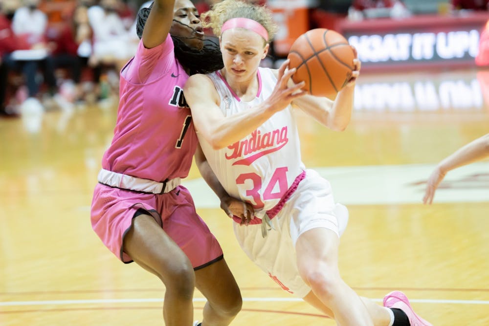 <p>Then-junior guard Grace Berger drives against the Iowa defense at Simon Skjodt Assembly Hall on March 3, 2021. Women’s Excellence is aimed to support IU’s female athletes through various development opportunities.</p>