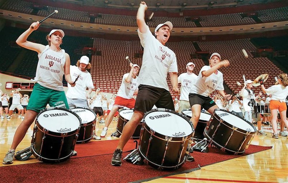 Bass drummers for the IU Marching Hundred perform during IU Traditions Friday afternoon at Assembly Hall. 