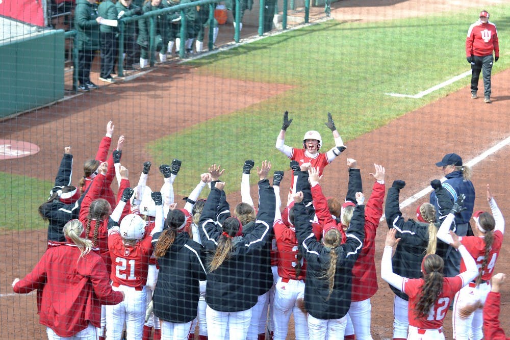 <p>The IU softball team celebrates as Grayson Radcliffe returns back to home base March 31 after hitting a home run in the second game of a double header versus Michigan State University. IU will play the University of Michigan on April 5-7.</p>