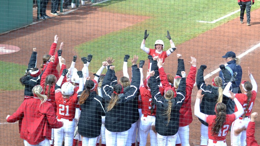 The IU softball team celebrates as Grayson Radcliffe returns back to home base March 31 after hitting a home run in the second game of a double header versus Michigan State University. IU will play the University of Michigan on April 5-7.