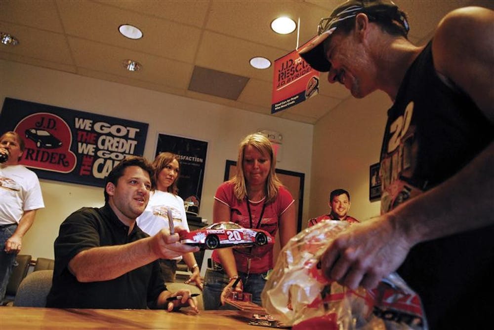 Bloomfield resident Mike Brucell got NASCAR driver Tony Stewart's autograph Thursday night at the J.D. Byrider Auto Sales Bloomington location. Brucell called Stewart his "favorite driver" and said he's been following the Columbus, Ind.-native since his rookie season in NASCAR.