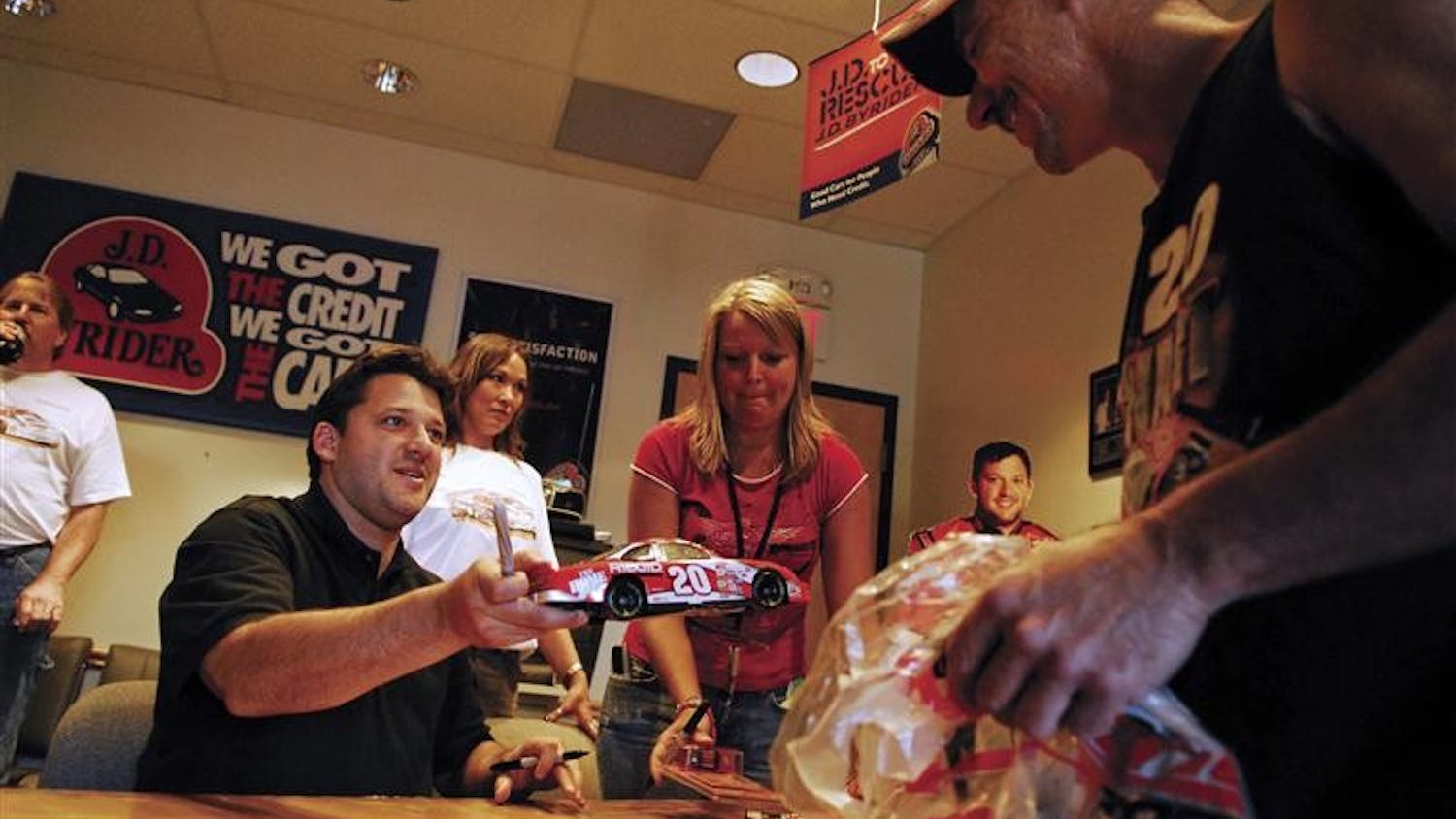 Bloomfield resident Mike Brucell got NASCAR driver Tony Stewart's autograph Thursday night at the J.D. Byrider Auto Sales Bloomington location. Brucell called Stewart his "favorite driver" and said he's been following the Columbus, Ind.-native since his rookie season in NASCAR.