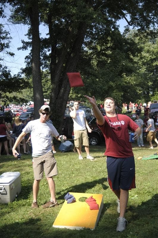 Matt Kaufman and Kevin Lawless, seniors, play cornhole before the IU vs Western Kentucky football game Saturday, August 30, at the tailgating fields.