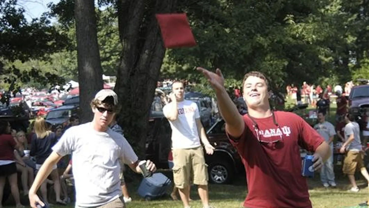 Matt Kaufman and Kevin Lawless, seniors, play cornhole before the IU vs Western Kentucky football game Saturday, August 30, at the tailgating fields.