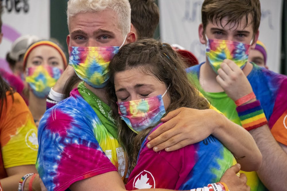 <p>IU junior Jason Wendt hugs senior Erin Daly during the end of the IU Dance Marathon on Oct. 31, 2021, at the IU Tennis Center. Wendt and Daly had just finished line dancing on-stage as part of Team Morale.</p>