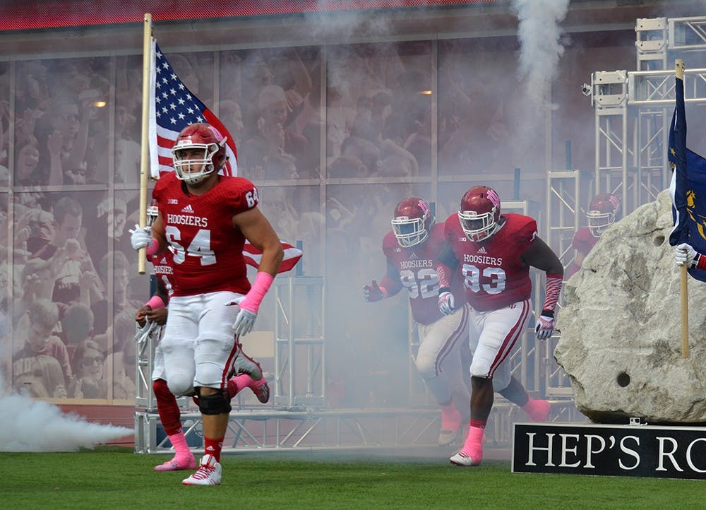 Senior center Collin Rahrig runs onto the field prior to IU's game against North Texas on Saturday at Memorial Stadium.
