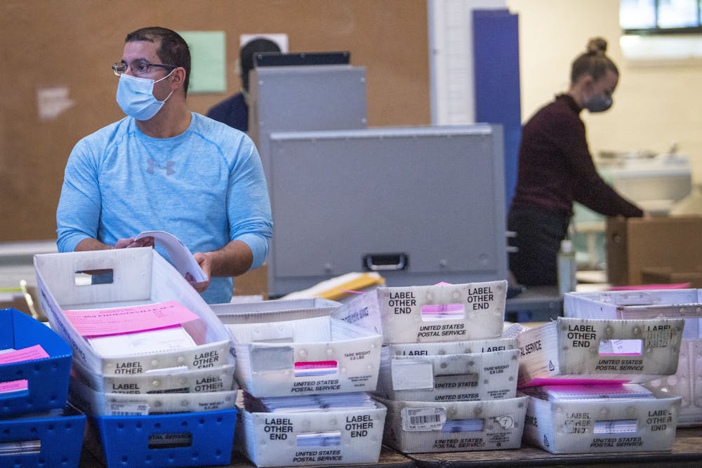 Chester County elections workers preparing mail ballots for processing during the 2020 vote count.