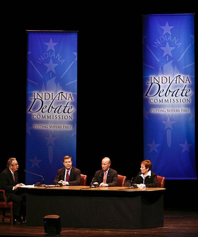 Moderator Tom Cochrun, and gubernatorial candidates Andy Horning, Mitch Daniels and Jill Long Thompson talk Tuesday evening at the IU Auditorium.