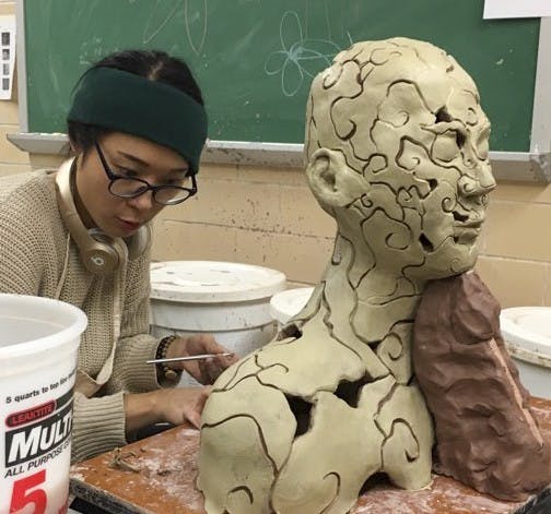 Won-Hee Parkby works on creating a ceramic bust. Parkby is BFA student at IU.