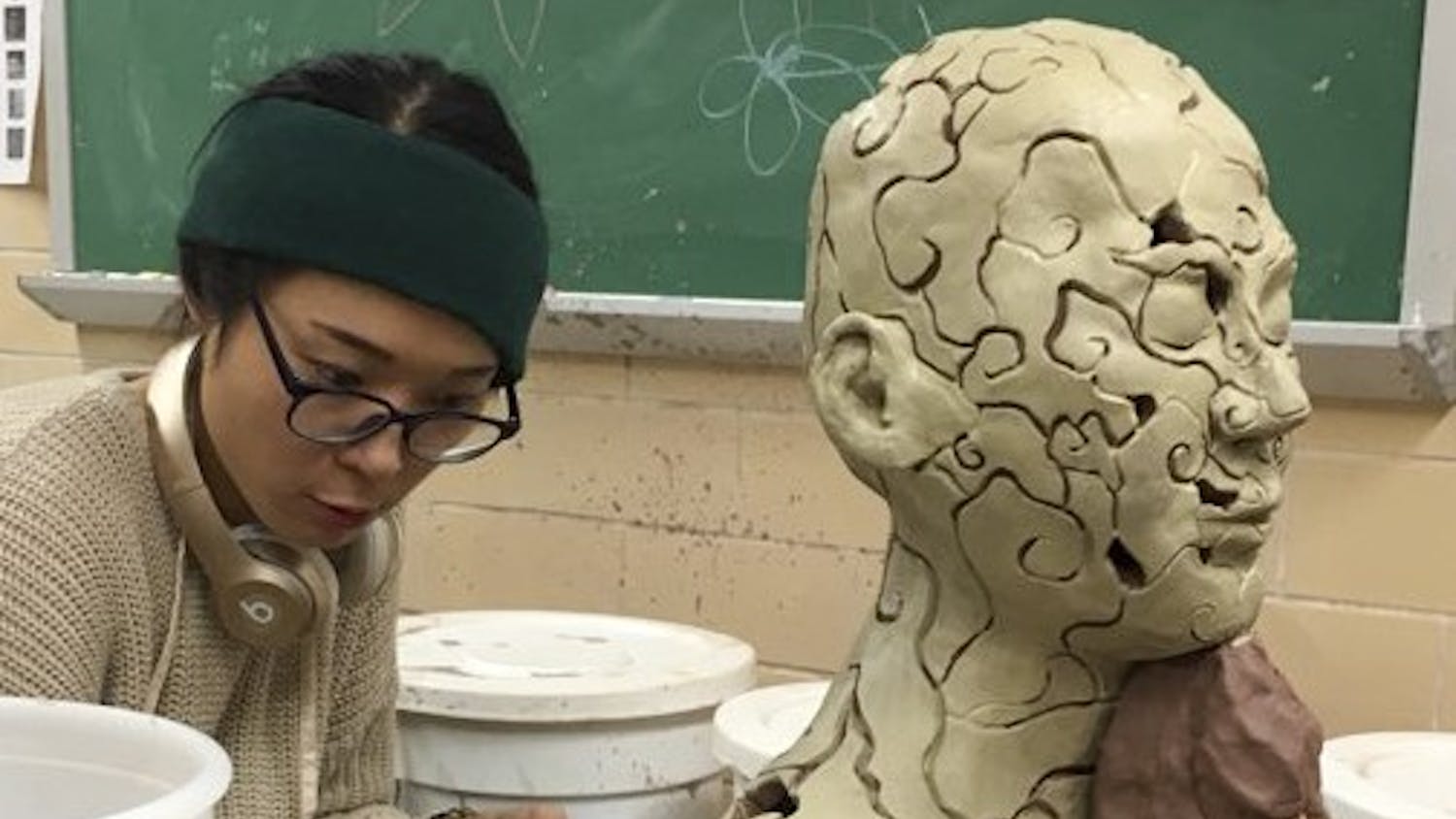 Won-Hee Parkby works on creating a ceramic bust. Parkby is BFA student at IU.