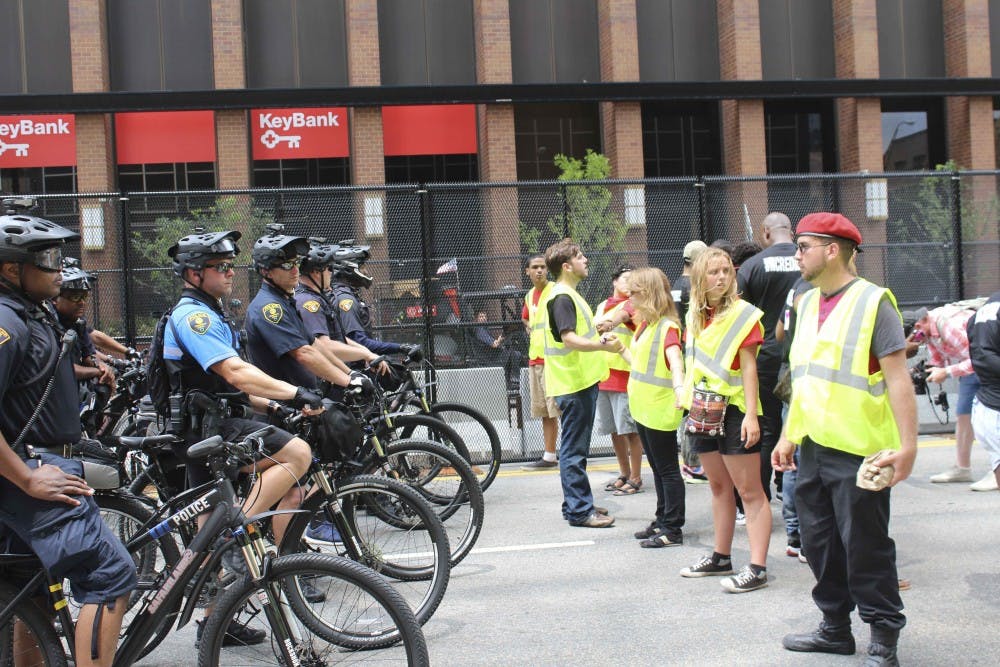police and Dump Trump protesters.