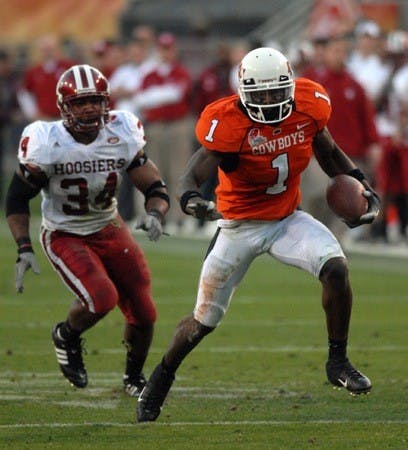 Jay Seawell • IDSOklahoma State freshman wide receiver Dez Bryant runs past IU linebacker Will Patterson during the Insight Bowl Monday evening at Sun Devil Stadium in Tempe, Ariz. Oklahoma State won 49-33.