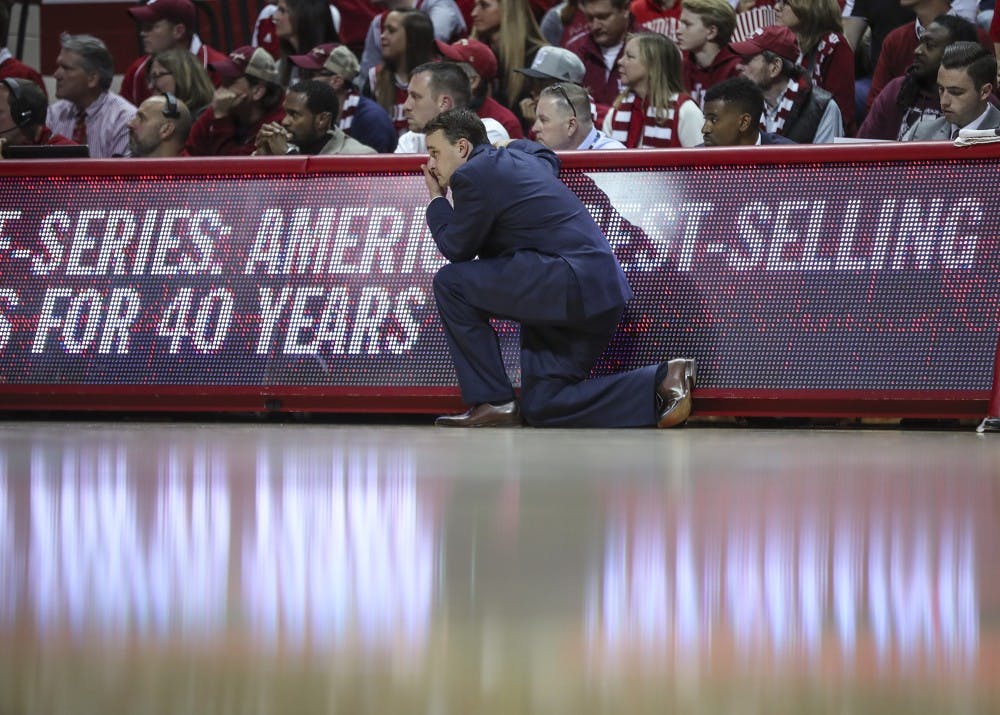 IU Coach Archie Miller kneels on the sideline during Indiana's game against the Indiana State Sycamores on Friday. This marked Miller's first regular season game as head coach of the Hoosiers.&nbsp;
