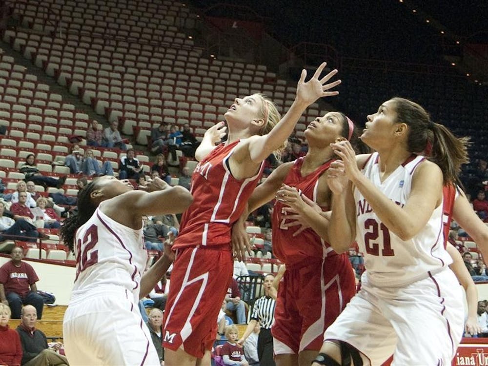 The IU women's basketball team and Miami (Ohio) watch the ball Thursday at Assembly Hall. IU lost 61-67 after making one of 20 three-point shot attempts.