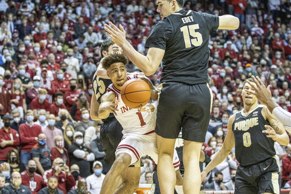 <p>Senior guard Rob Phinisee passes around Purdue sophomore center Zach Edey on Jan. 20, 2022, at Simon Skjodt Assembly Hall. Phinisee scored 8 points in the game against Minnesota on Feb. 27, 2022.  </p>
