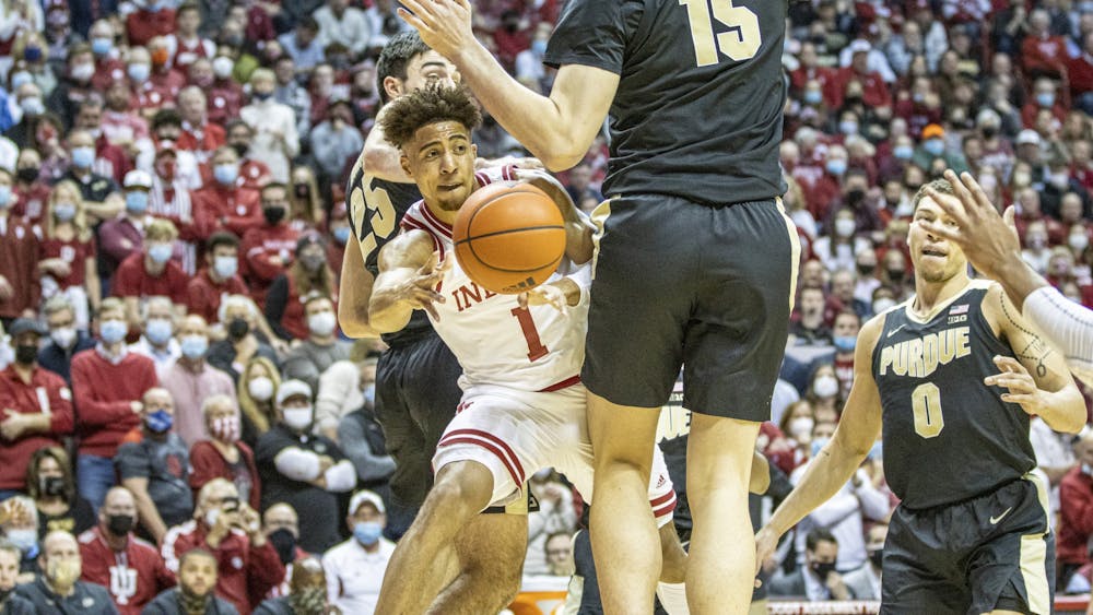 Senior guard Rob Phinisee passes around Purdue sophomore center Zach Edey on Jan. 20, 2022, at Simon Skjodt Assembly Hall. Phinisee scored 8 points in the game against Minnesota on Feb. 27, 2022.  