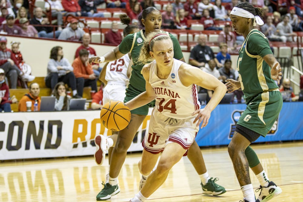 <p>Senior guard Grace Berger dribbles out of a double team against University of North Carolina at Charlotte in the First Round of the NCAA Tournament on March 19, 2022, at Simon Skjodt Assembly Hall. This is Indiana’s first time hosting a game in the Women’s NCAA Tournament.</p>