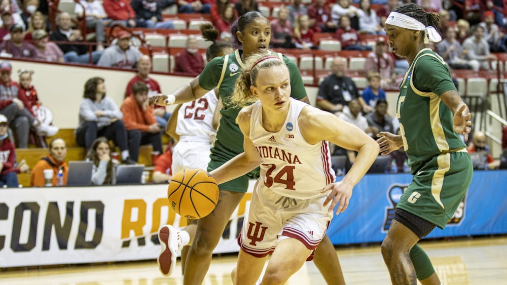Senior guard Grace Berger dribbles out of a double team against University of North Carolina at Charlotte in the First Round of the NCAA Tournament on March 19, 2022, at Simon Skjodt Assembly Hall. This is Indiana’s first time hosting a game in the Women’s NCAA Tournament.