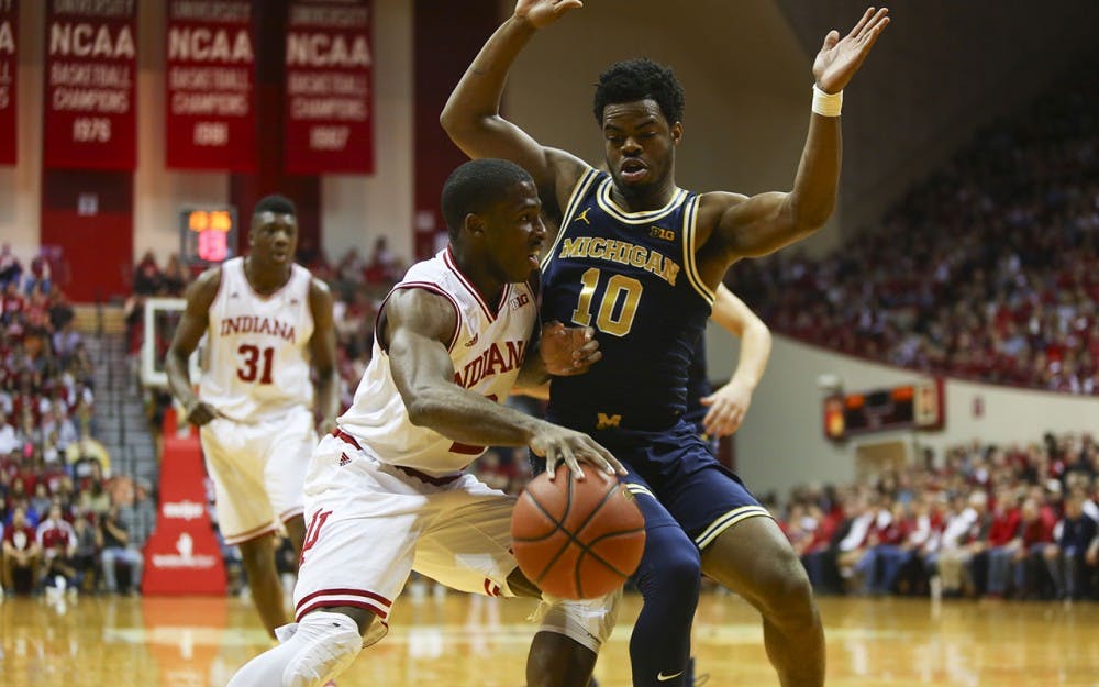Junior guard Josh Newkirk fights for control in front of the Michigan net Sunday. 