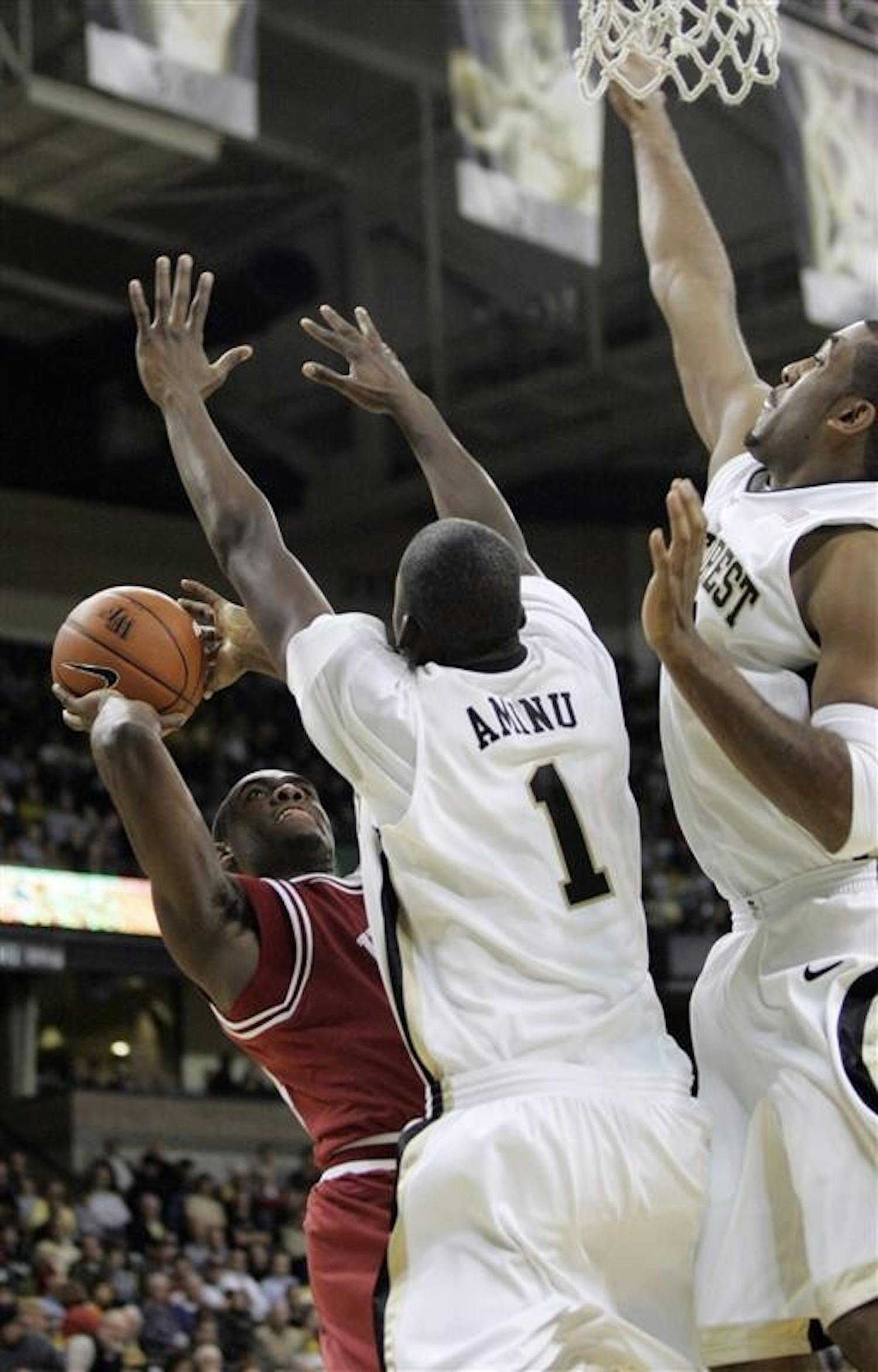 Wake Forest defenders swarm IU's Malik Story as he attempts a shot during IU's 83-58 loss Wednesday night in Winston-Salem, N.C. Wake Forest's defense forced 26 turnovers.