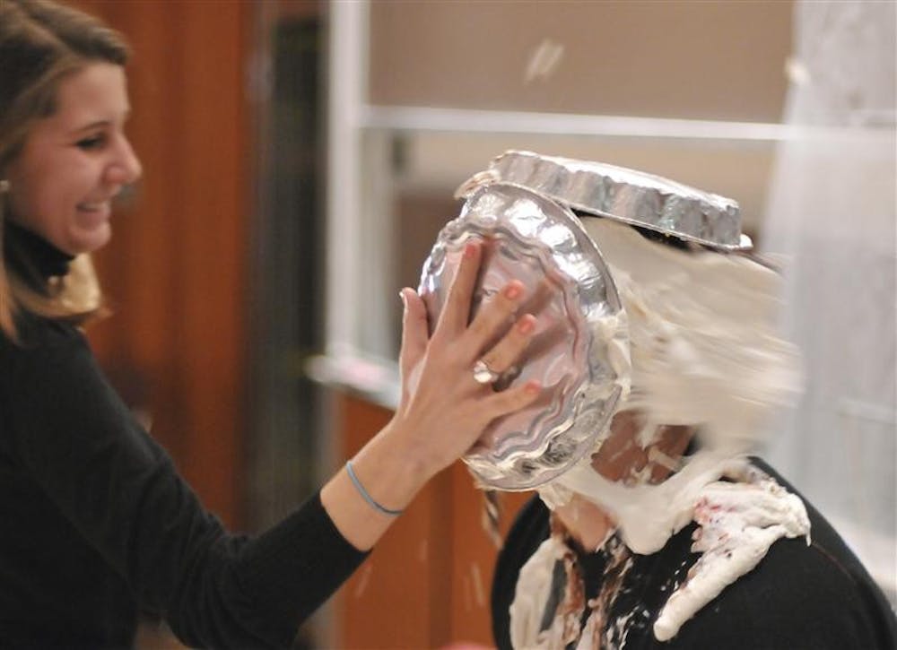 Professor Steven Kreft gets pied during Pie-A-Professor on Tuesday evening at the Kelley School of Business. All of the proceeds from the event will go to Big Brothers Big Sisters.