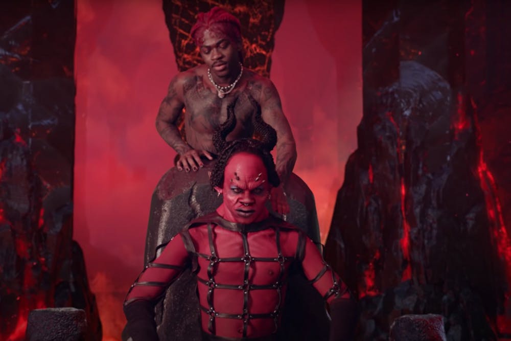 <p>Lil Nas X dances behind a portrayal of the devil in a screenshot from the music video for his song &quot;MONTERO (Call Me By Your Name).&quot; The video sparked an internet controversy after its release March 26 due to its sexual and demonic themes.</p>