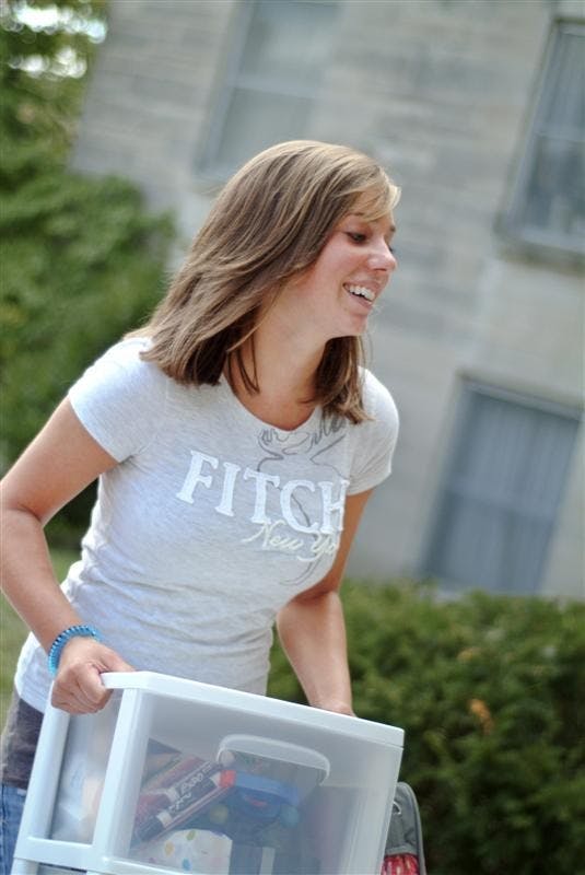 Nicole Jakubowicz moves stuff to her room Wednesday afternoon at Teter Quad.