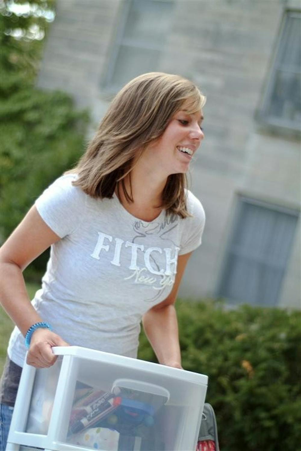 Nicole Jakubowicz moves stuff to her room Wednesday afternoon at Teter Quad.